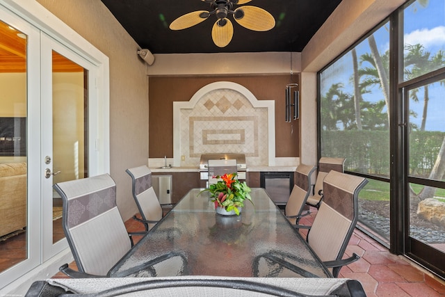 sunroom featuring ceiling fan