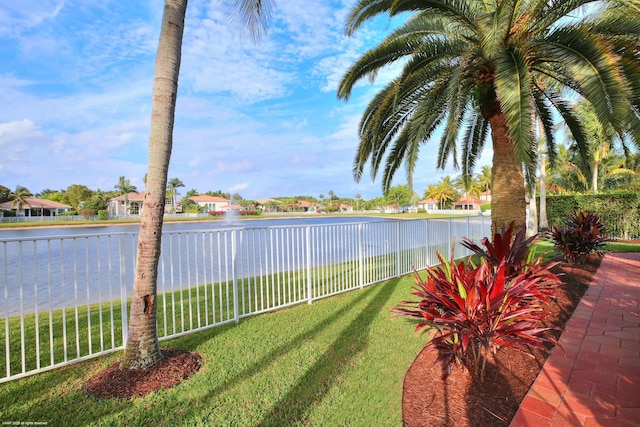 view of yard featuring a water view and fence