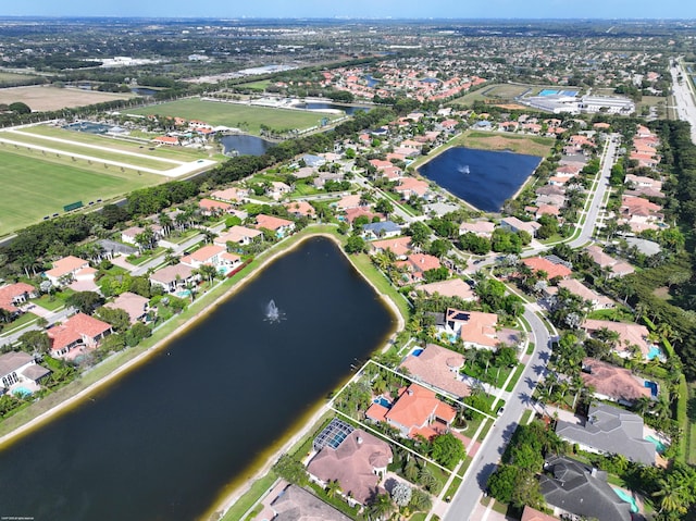 birds eye view of property with a water view and a residential view