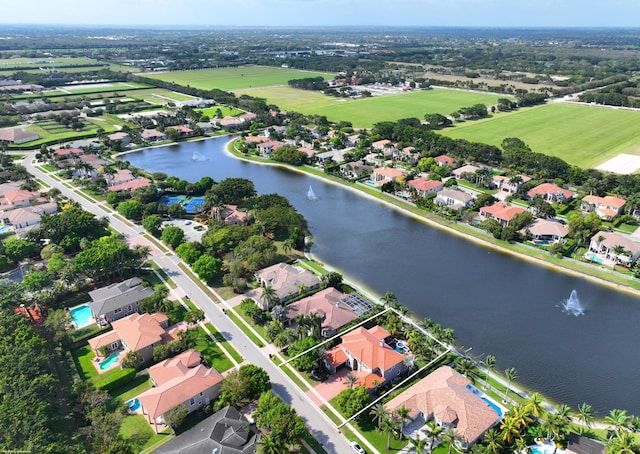 drone / aerial view featuring a residential view and a water view