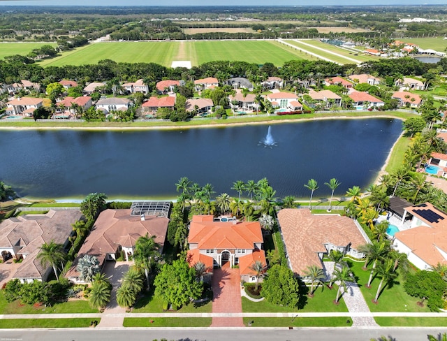 drone / aerial view featuring a residential view and a water view