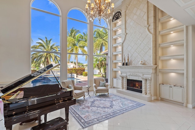 sitting room featuring tile patterned floors, built in features, a fireplace, and a chandelier