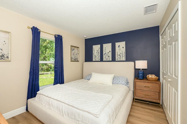 bedroom featuring light hardwood / wood-style flooring and a closet