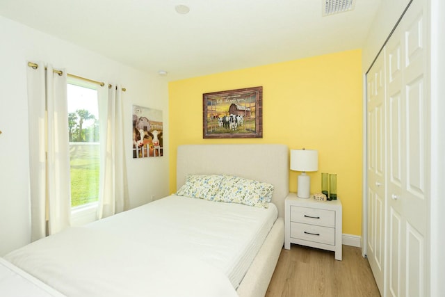 bedroom featuring a closet and light wood-type flooring