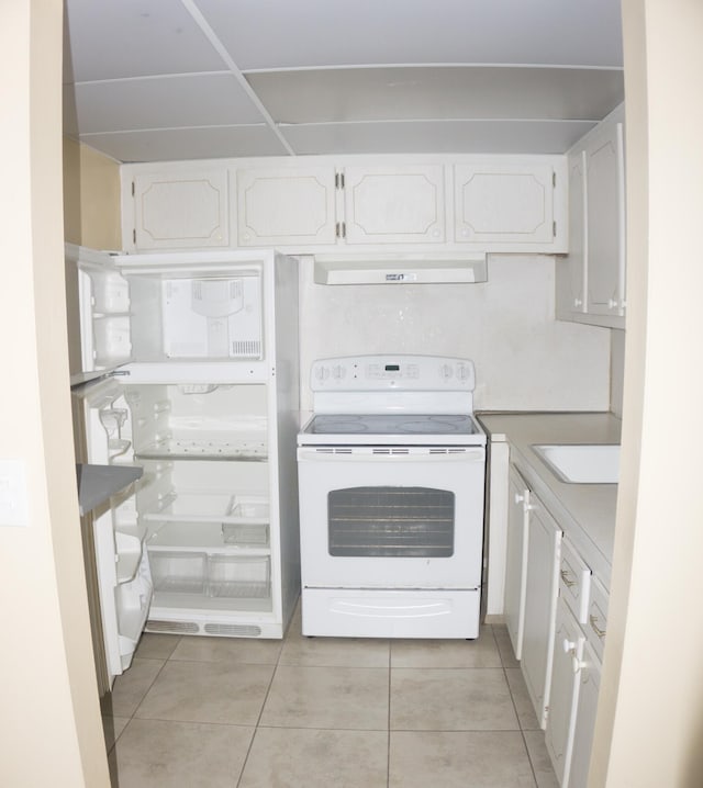 kitchen with extractor fan, sink, white cabinets, white electric range, and light tile patterned flooring