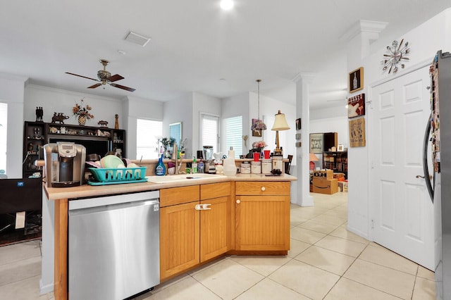 kitchen with stainless steel dishwasher, sink, hanging light fixtures, ceiling fan, and light tile patterned floors