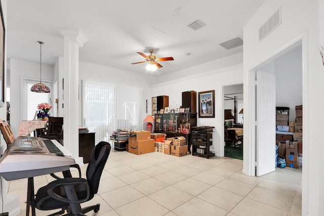 office space featuring decorative columns, ceiling fan, and light tile patterned floors