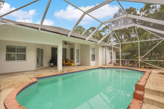 view of swimming pool with ceiling fan, a patio, and a lanai