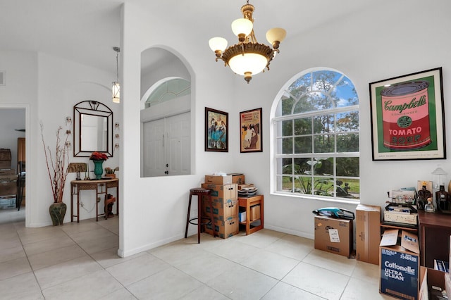 tiled home office featuring a chandelier