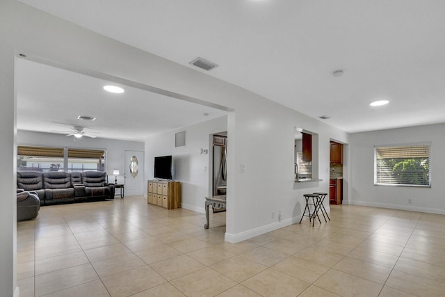 living room with ceiling fan and light tile patterned floors