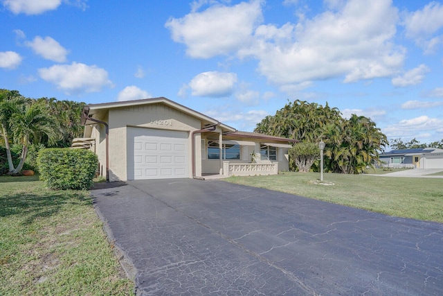 ranch-style home with a front yard and a garage