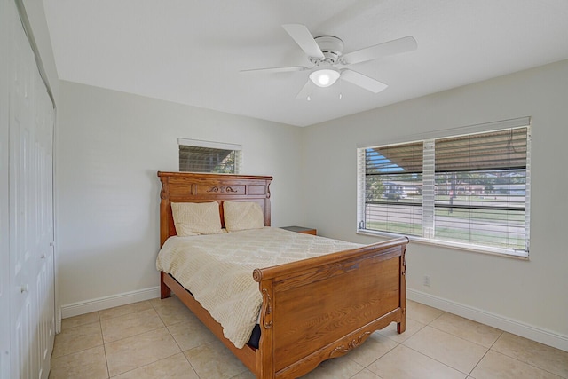 bedroom featuring ceiling fan, a closet, and light tile patterned flooring