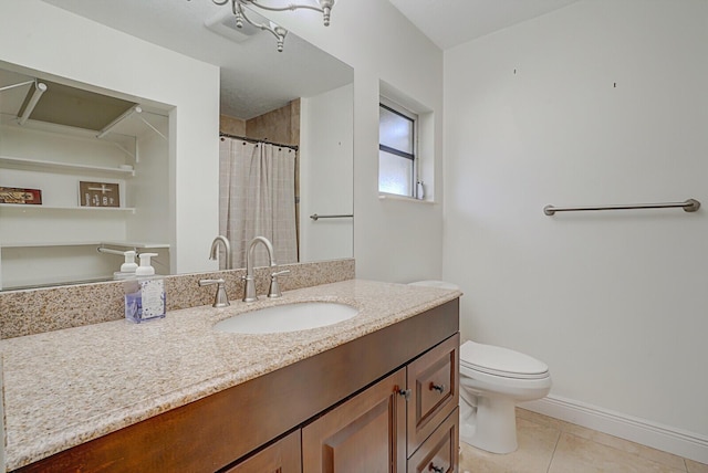 bathroom with tile patterned floors, vanity, and toilet