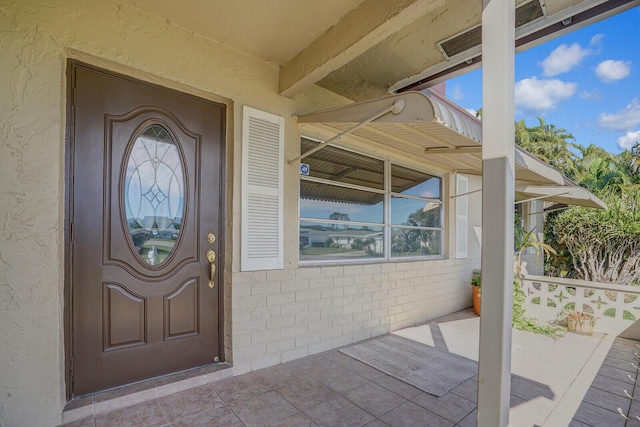 view of exterior entry featuring a porch