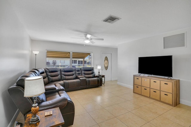 tiled living room with ceiling fan and a textured ceiling