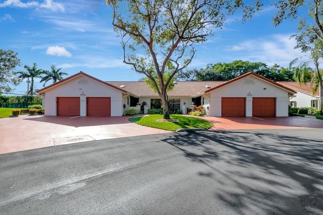 view of front facade featuring concrete driveway, a garage, and stucco siding