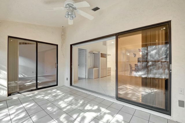 interior space featuring tile patterned floors, a ceiling fan, and visible vents