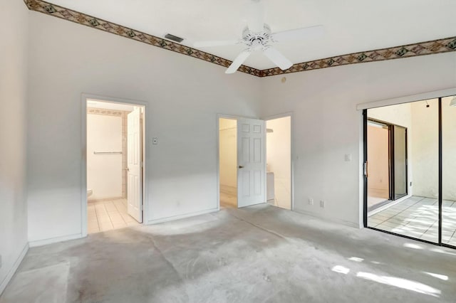 unfurnished bedroom featuring ceiling fan, a closet, connected bathroom, and carpet flooring