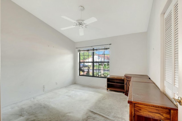 interior space featuring carpet floors, ceiling fan, and vaulted ceiling