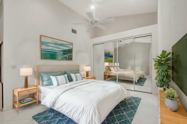 bedroom featuring a closet, light tile patterned floors, and visible vents