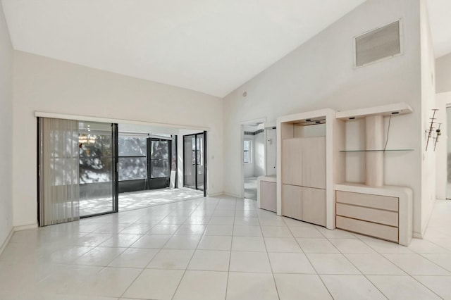 unfurnished room featuring light tile patterned floors, baseboards, visible vents, and high vaulted ceiling