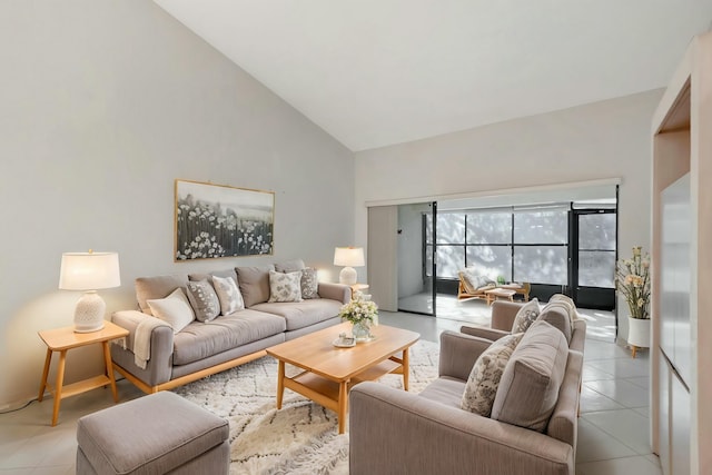 living area featuring light tile patterned flooring and high vaulted ceiling