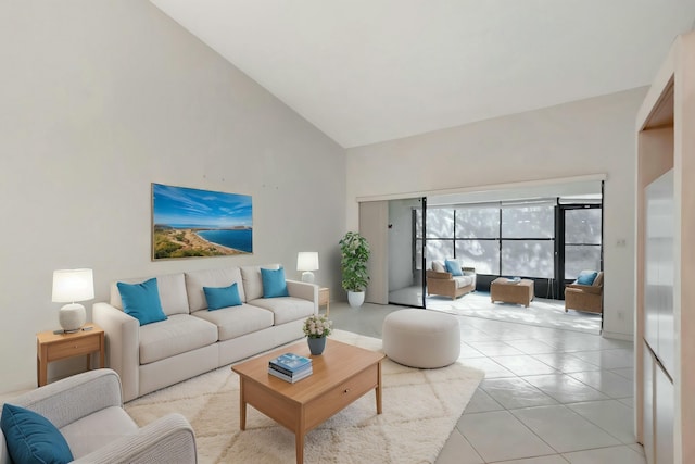 living area featuring light tile patterned floors and high vaulted ceiling