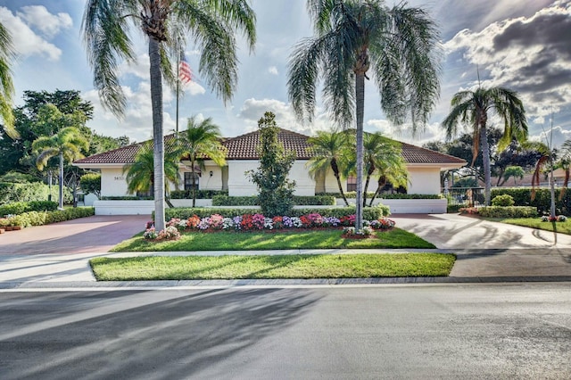 mediterranean / spanish home featuring stucco siding and driveway