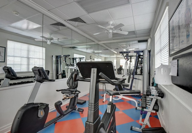 exercise room featuring visible vents, ceiling fan, and a drop ceiling