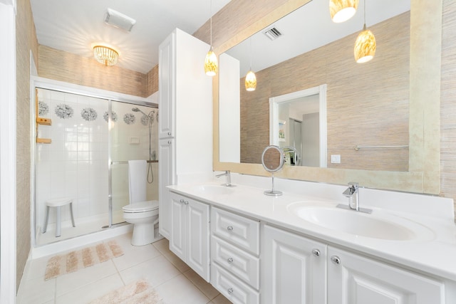 bathroom with toilet, vanity, tile patterned floors, and walk in shower