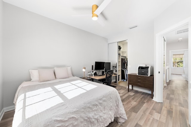 bedroom featuring ceiling fan, a closet, and wood-type flooring