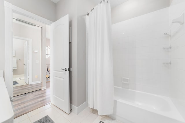 bathroom featuring tile patterned flooring and shower / bath combo with shower curtain