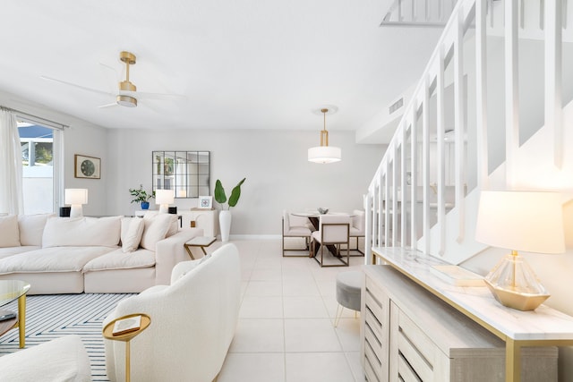 tiled living room featuring ceiling fan