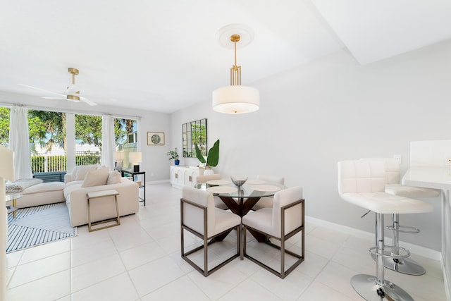 tiled dining area with ceiling fan