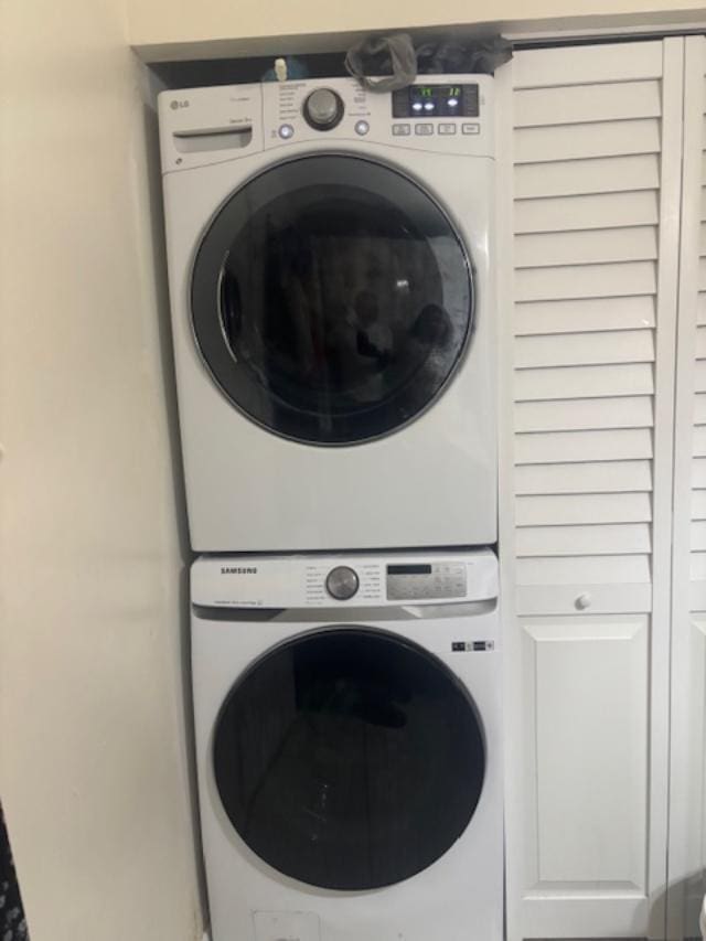 washroom featuring stacked washing maching and dryer