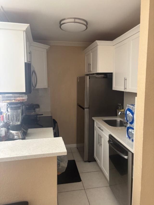 kitchen featuring sink, light tile patterned floors, black dishwasher, white cabinets, and ornamental molding