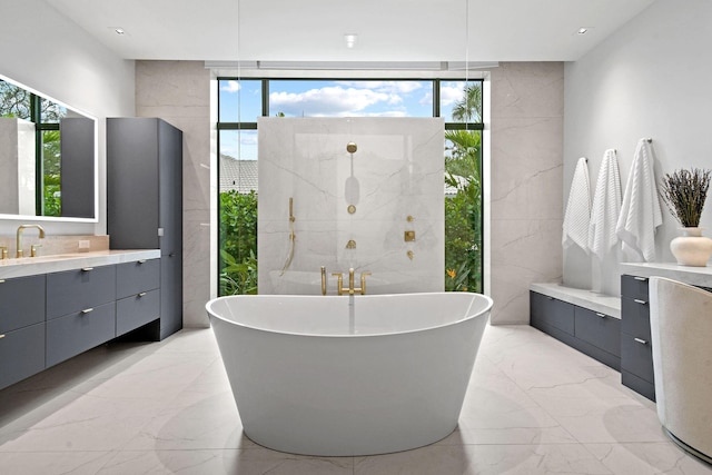 bathroom featuring a bathtub, tile walls, and vanity