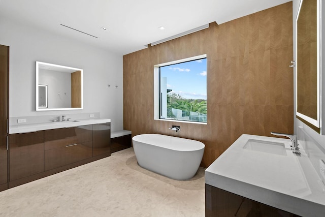 bathroom featuring vanity and a tub