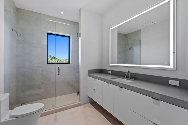 bathroom featuring tile patterned flooring, vanity, toilet, and an enclosed shower