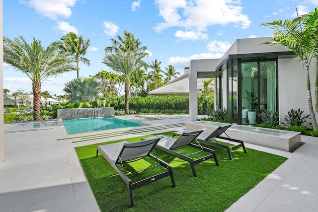 view of pool featuring pool water feature and a patio area