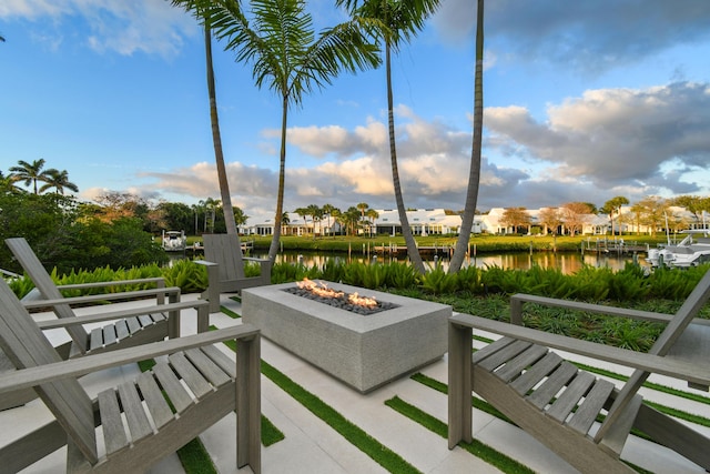 view of patio / terrace with a water view and an outdoor fire pit