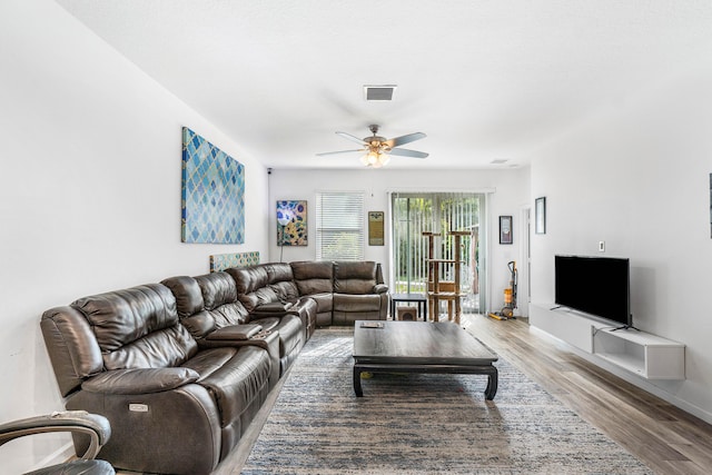 living room with hardwood / wood-style flooring and ceiling fan