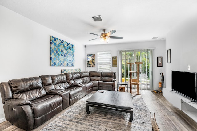 living room featuring wood-type flooring and ceiling fan