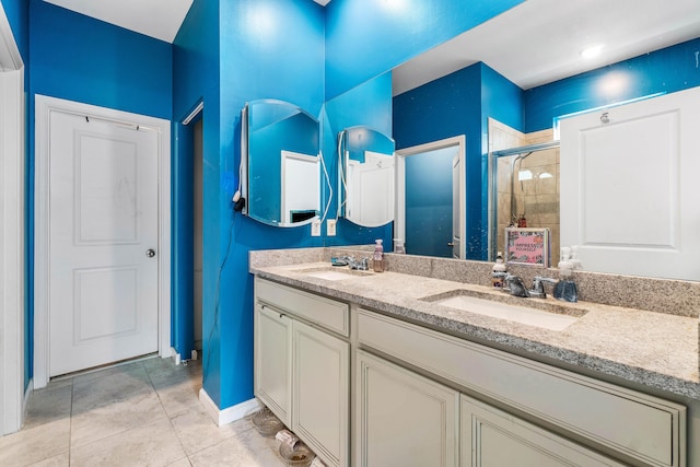 bathroom featuring tile patterned floors, vanity, and walk in shower