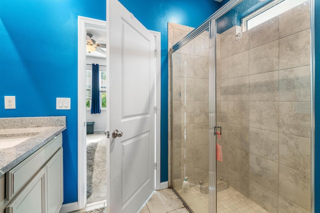 bathroom featuring tile patterned flooring, ceiling fan, an enclosed shower, and vanity