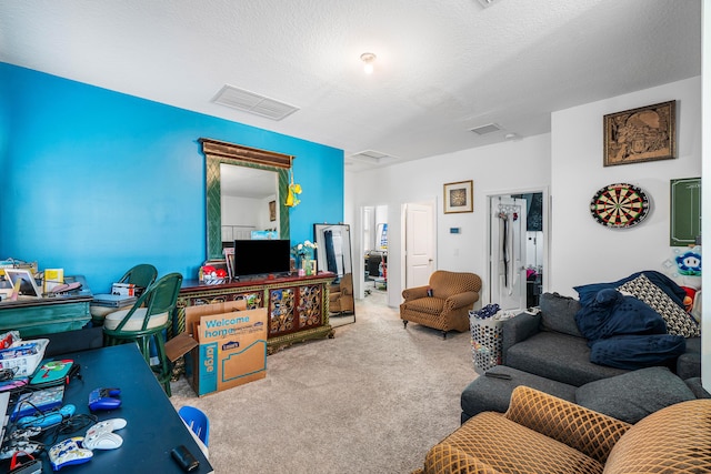 living room featuring carpet and a textured ceiling