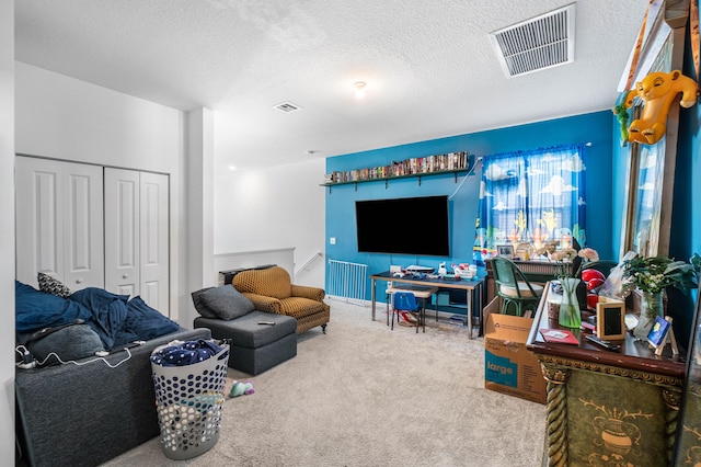 living room featuring carpet and a textured ceiling