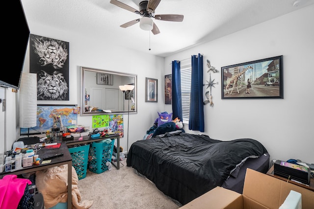 bedroom with a textured ceiling, light colored carpet, and ceiling fan