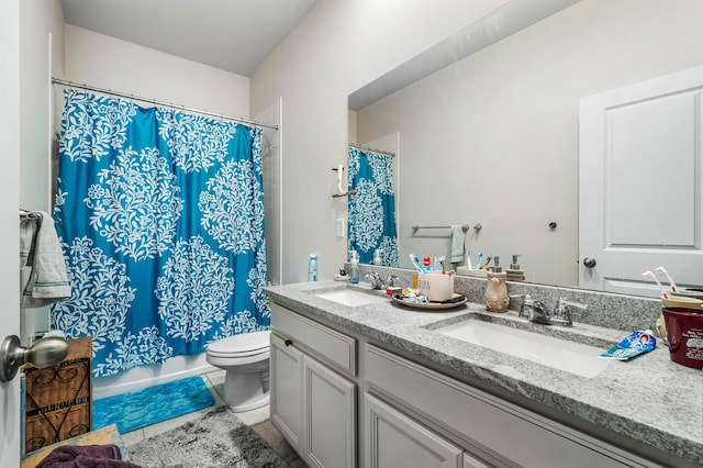 full bathroom featuring tile patterned flooring, vanity, toilet, and shower / bathtub combination with curtain