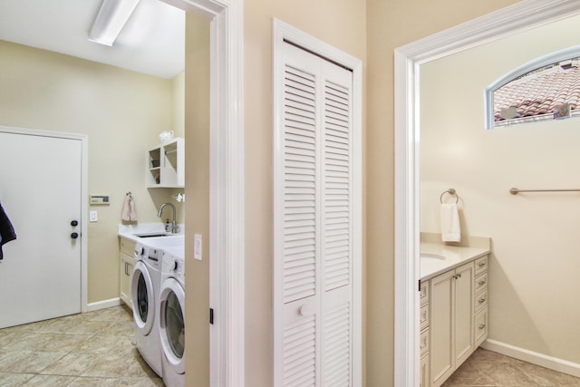 laundry room featuring sink, cabinets, and independent washer and dryer